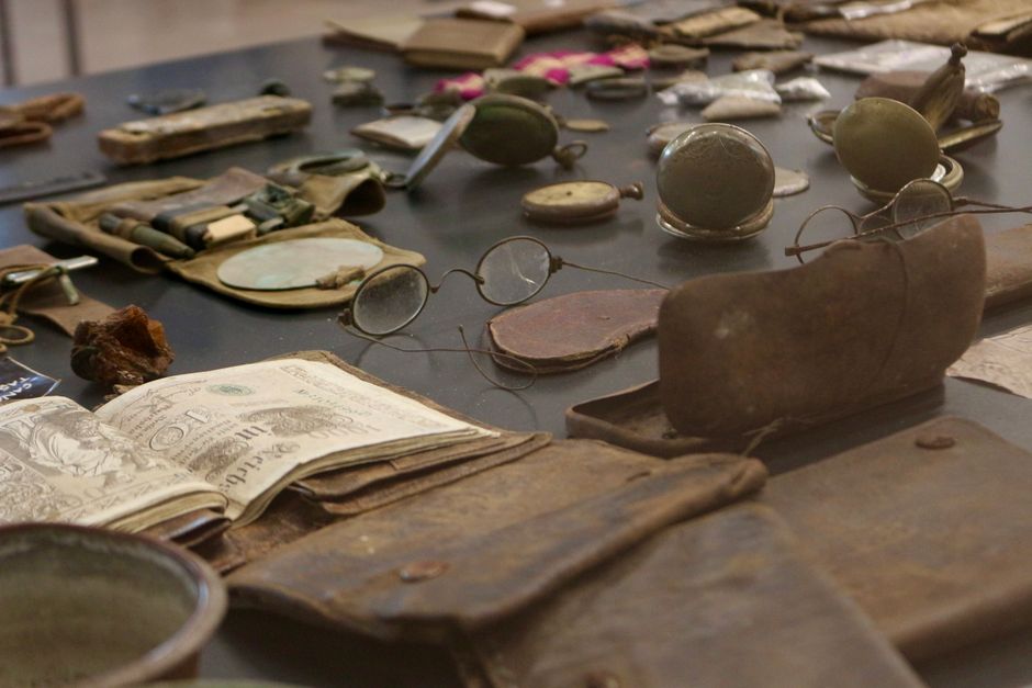 A detailed view of antique artifacts including glasses and documents on display.